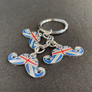 Keychain with British flag-themed mustache charms on a gray background